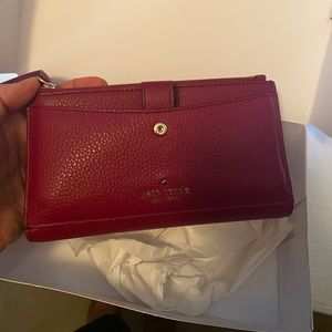 BRAND NEW Kate Spade wristlet. Magenta colored.